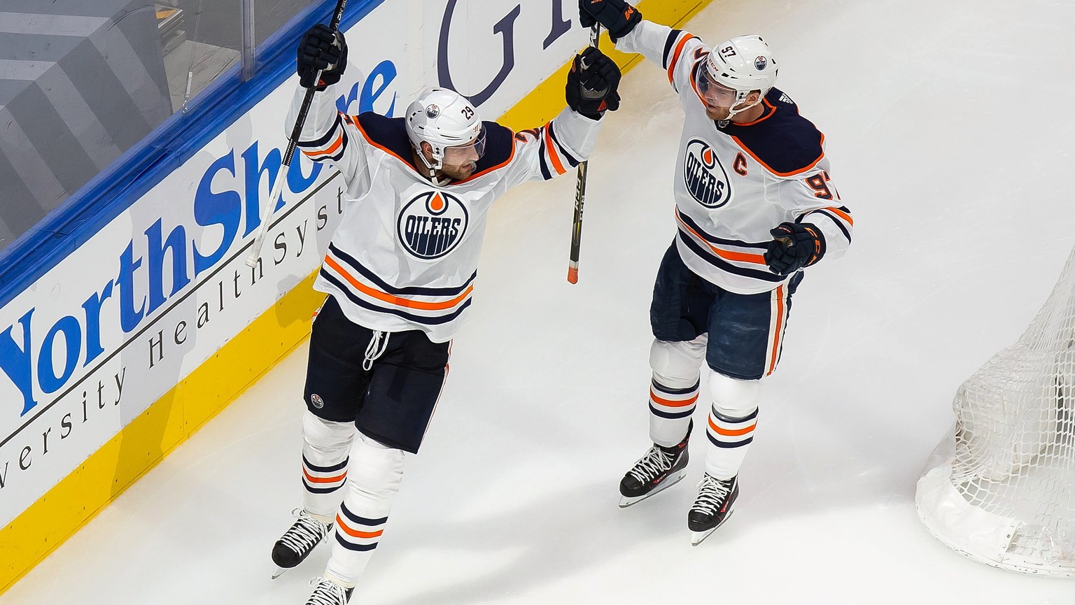 Edmonton Oilers' Leon Draisaitl (29) and Connor McDavid (97) celebrate a goal against the Chicago Blackhawks during the second period of an NHL hockey playoff game Wednesday, Aug. 5, 2020, in Edm ...