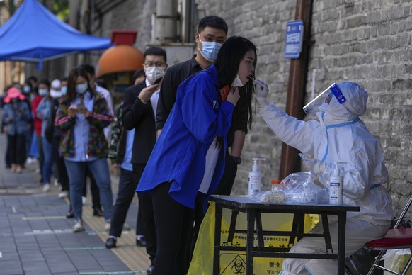 Residents line up for COVID-19 testing in the Chaoyang district on Wednesday, May 11, 2022, in Beijing. Shanghai reaffirmed China&#039;s strict &quot;zero-COVID&quot; approach to pandemic control Wedn ...