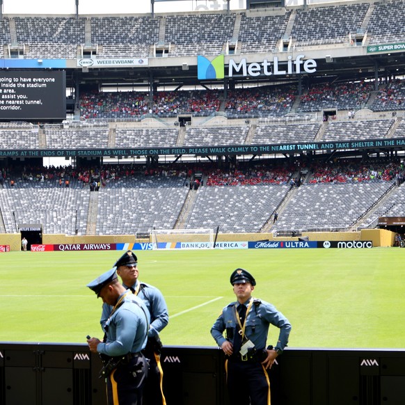 epa12186048 New Jersey state police look on as the match was interrupted and spectatores asked to leave their seats following a severe weather warning in the area during the FIFA Club World Cup 2025 m ...