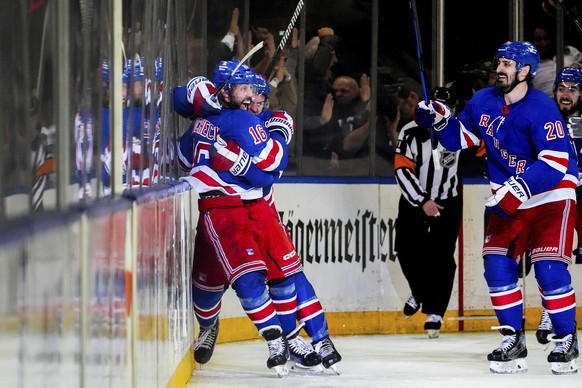 New York Rangers left wings Chris Kreider (20) and defenseman Adam Fox (23) react to center Vincent Trocheck&#039;s (16) game-winning goal in the second overtime in Game 2 of an NHL hockey Stanley Cup ...
