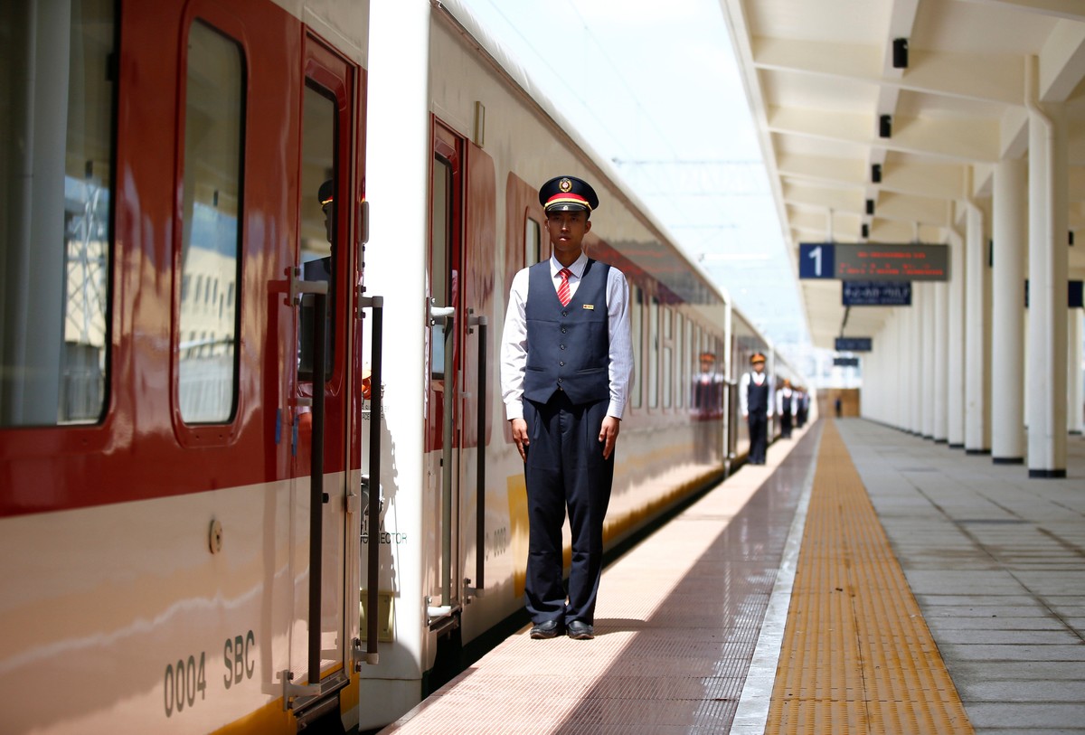 Chinese engineers stand in a line near a train at Furi train station during a media guided tour of the Ethio-Djibouti Railways route near Ethiopia's capital Addis Ababa, September 24, 2016. REUTE ...