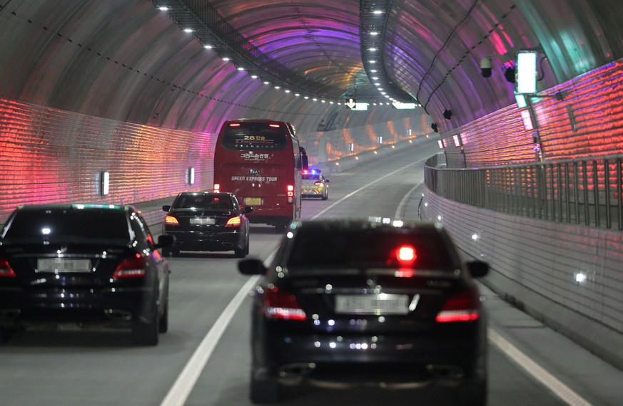 epa09612156 A bus carrying Prime Minister Kim Boo-kyum and sedans take a test-drive through an undersea tunnel after its opening ceremony in Boryeong, South Korea, 30 November 2021, 11 years after con ...