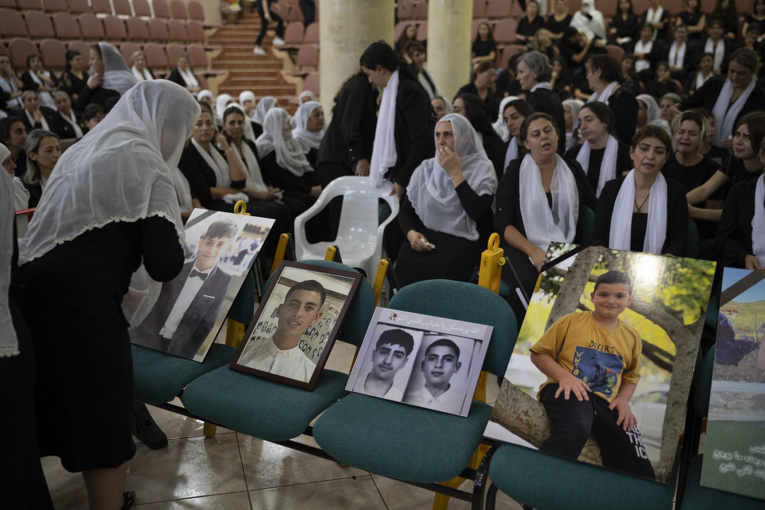 Members of the Druze minority attend a memorial ceremony Monday, July 29, 2024, for the children and teens, killed in a rocket strike at a soccer field over the weekend in the village of Majdal Shams, ...