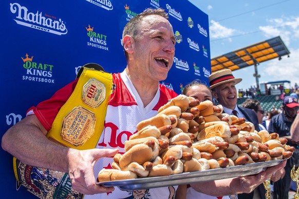 FILE - Joey Chestnut, winner of the 2021 Nathan's Famous Fourth of July International Hot Dog-Eating Contest, poses for photos in Coney Island's Maimonides Park, July 4, 2021, in the Brookly ...