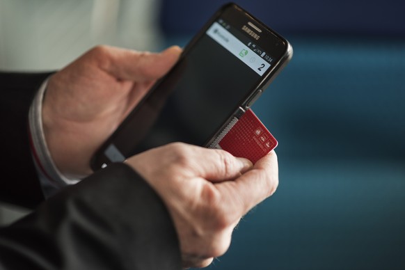 ARCHIV - ZUR GEPLANTEN SENKUNG DER BILLETPREISE DURCH DIE SBB, AM SAMSTAG, 02. DEZEMBER 2017, ERHALTEN SIE FOLGENDE ARCHIVBILDER ---- A train conductor of the Swiss Federal Railways checks a passenger ...