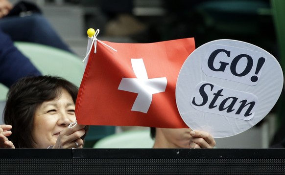 Fans support Switzerland&#039;s Stan Wawrinka playing Serbia&#039;s Viktor Troicki during their third round match at the Australian Open tennis championships in Melbourne, Australia, Friday, Jan. 20,  ...