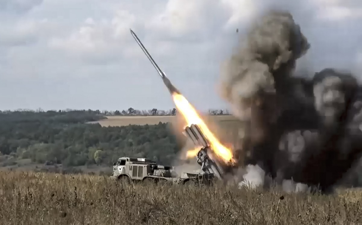 epa10194927 A still image taken from a handout video made available by the Russian Defence Ministry press-service on 20 September 2022 shows a BM-27 Uragan multiple-launch rocket system of Russia' ...