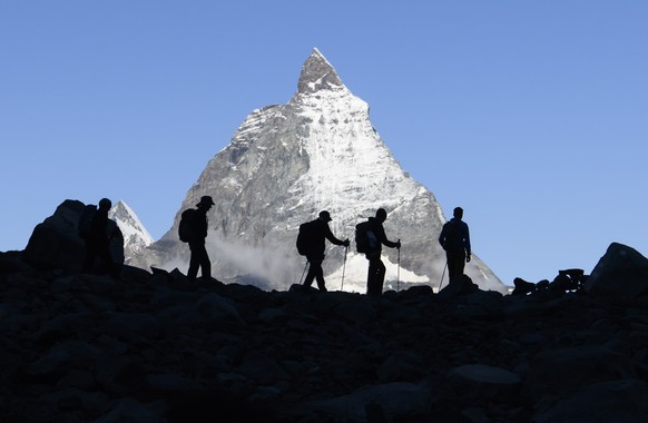 epa09473564 Festival-goers come down after a concert of the French Band Tournee des Refuges the day before at the Monte Rosa Hut (2,883m), with a view of Cervin (Matterhorn) Mountain, during the Zerma ...