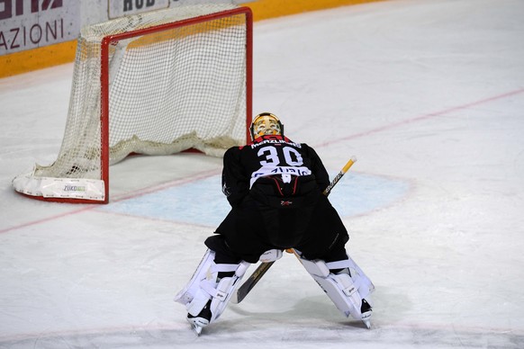 Lugano&#039;s goalkeeper Elvis Merzlikins reacts after the second leg of the playoff quarterfinals of the ice hockey National League Swiss Championship between HC Lugano and EV Zug, at the ice stadium ...