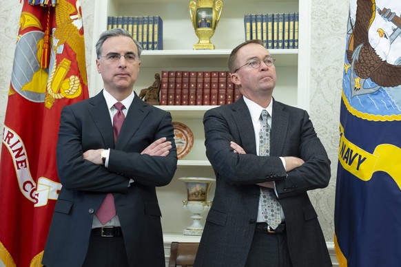 epa07224268 White House Counsel Pat Cipollone (L) and Director of the Office of Management and Budget and Acting Director of the Consumer Financial Protection Bureau Mick Mulvaney (R) attend a meeting ...