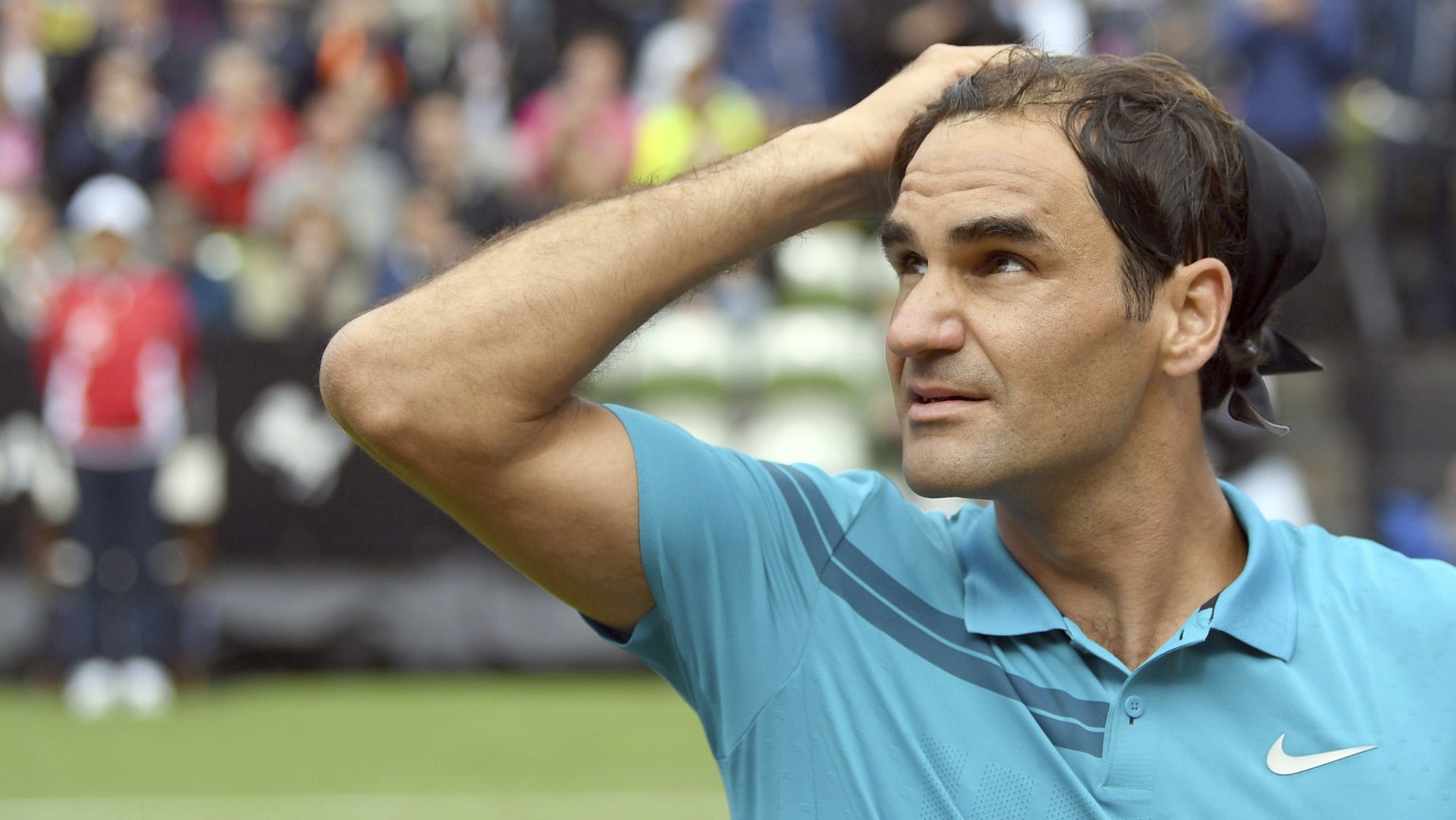 Roger Federer reacts as he defeats Mischa Zverev during the ATP Mercedes Cup tournament in Stuttgart, Germany, Wednesday, June 13, 2018. (Marijan Murat/dpa via AP)