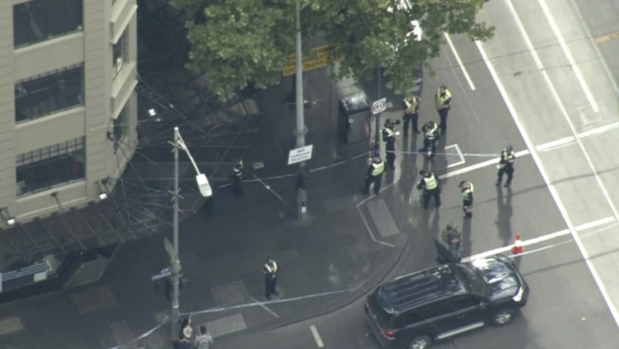 This image made from video shows police on street corner after a shooting in Melbourne, Australia, Friday, Nov. 9, 2018. Police shot a knife-wielding man Friday after he fatally stabbed one person and ...