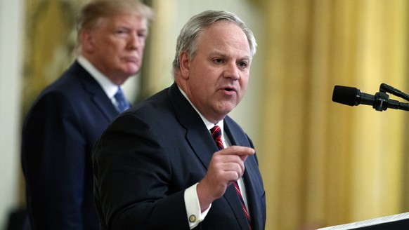 FILE - In this July 8, 2019 file photo President Donald Trump listens as Secretary of the Interior David Bernhardt speaks during an event on the environment in the East Room of the White House in Wash ...