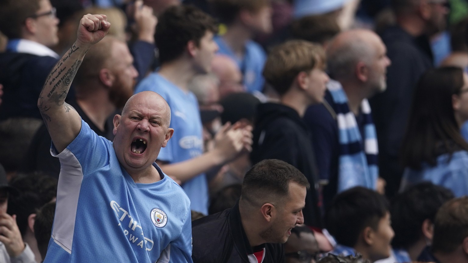 Manchester City fans shouts during the English Premier League soccer match between Manchester City and Aston Villa at the Etihad Stadium in Manchester, England, Sunday, May 22, 2022. (AP Photo/Dave Th ...