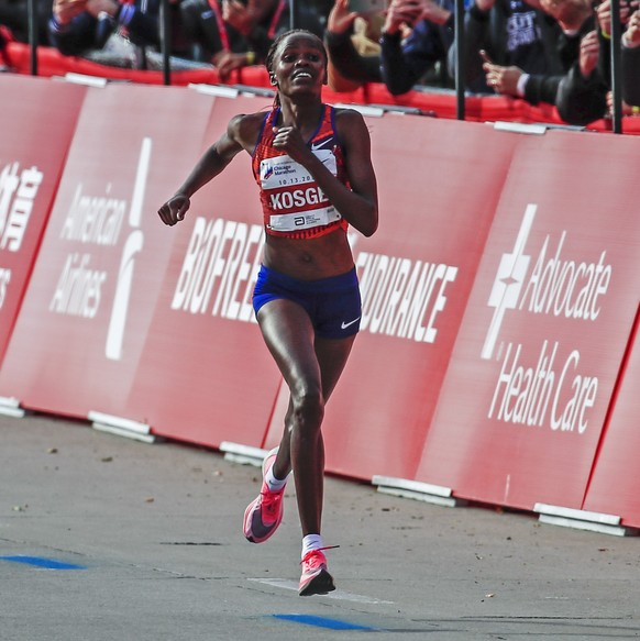 epa07918365 Brigid Kosgei of Kenya heads to the finish line to win with a women world record time of 02:14:04 in the 2019 Chicago Marathon in Chicago, Illinois, USA, 13 October 2019. The Chicago Marat ...