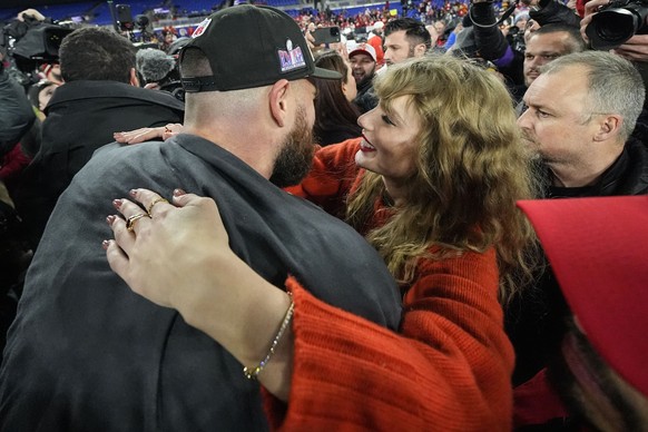 Taylor Swift speaks withKansas City Chiefs tight end Travis Kelce after an AFC Championship NFL football game against the Baltimore Ravens, Sunday, Jan. 28, 2024, in Baltimore. The Kansas City Chiefs  ...