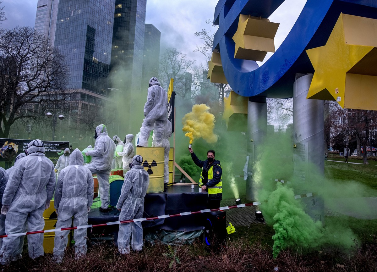 Environmental activists of Greenpeace and the "Koala Kollektiv" protest against the European Union's greenwashing of nuclear energy under the Euro sculpture in Frankfurt, Germany, Tuesd ...