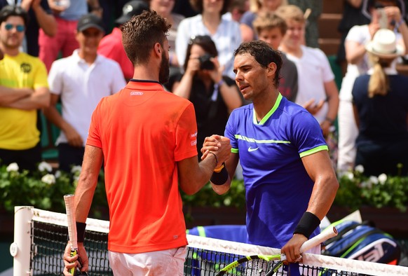 epa05997603 Rafael Nadal of Spain reacts with Benoit Paire of France after winning their men’s 1st round single match during the French Open tennis tournament at Roland Garros in Paris, France, 29 May ...