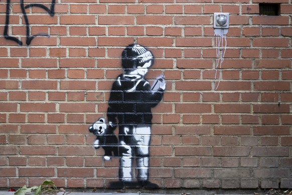 epa13048934 A wall painting, which may have been created by the British street artist Banksy, can be seen on a wall at the exhibition centre where the art fair ART Basel 2026 is currently taking place ...