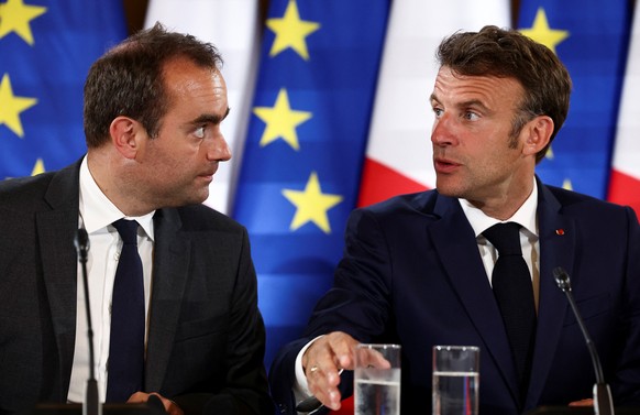 epa10700642 French Minister of the Armed Forces Sebastien Lecornu (L) and French President Emmanuel Macron speak during the European Air Defense Conference, attended by EU defense ministers, on the si ...