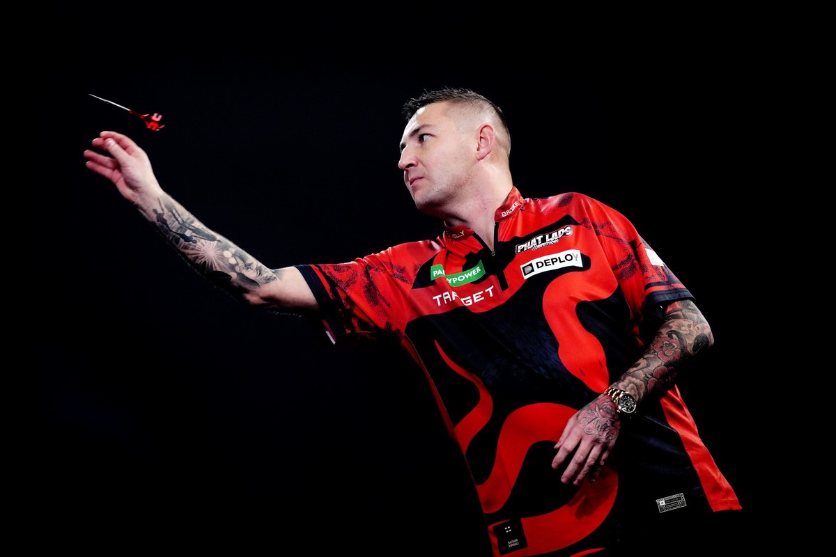 England's Nathan Aspinall competes against Leonard Gates of the U.S. on day twelve of the Paddy Power World Darts Championship, in London, Monday Dec. 22, 2025. (John Walton/PA via AP)