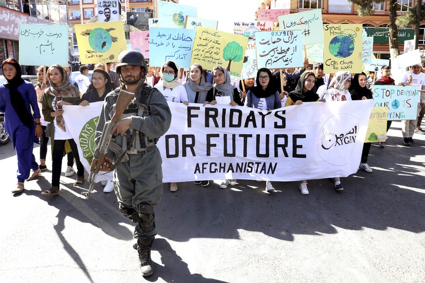 Young people attend a Climate Strike rally, as Afghan security forces guard them in Kabul, Afghanistan, Friday, Sept. 20, 2019. In the Afghan capital, where people are dying every day in horrific bomb ...