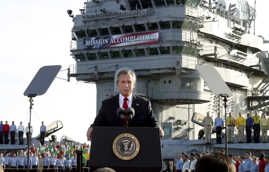 FILE - President George W. Bush speaks aboard the aircraft carrier USS Abraham Lincoln off the California coast on May 1, 2003. (AP Photo/J. Scott Applewhite, File)