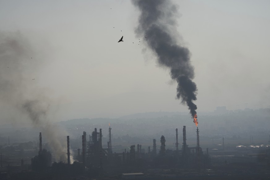 Smoke billows after an Iranian missile struck an oil refinery in Haifa, northern Israel, early Monday, June 16, 2025. (AP Photo/Ariel Schalit)
Israel Iran Mideast Wars