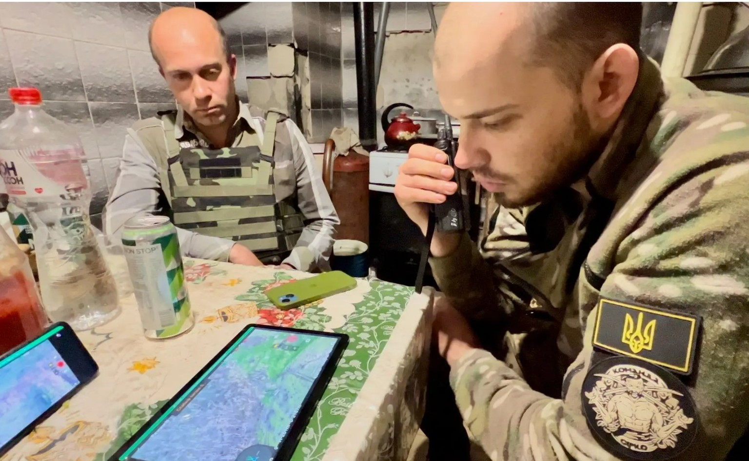 Ukrainian commander Ivan (right) in his headquarters.