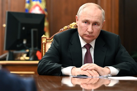 Russian President Vladimir Putin listens to VTB Bank Chairman Andrei Kostin during their meeting at the Kremlin in Moscow, Russia, Thursday, Aug. 10, 2023. (Mikhail Klimentyev, Sputnik, Kremlin Pool P ...