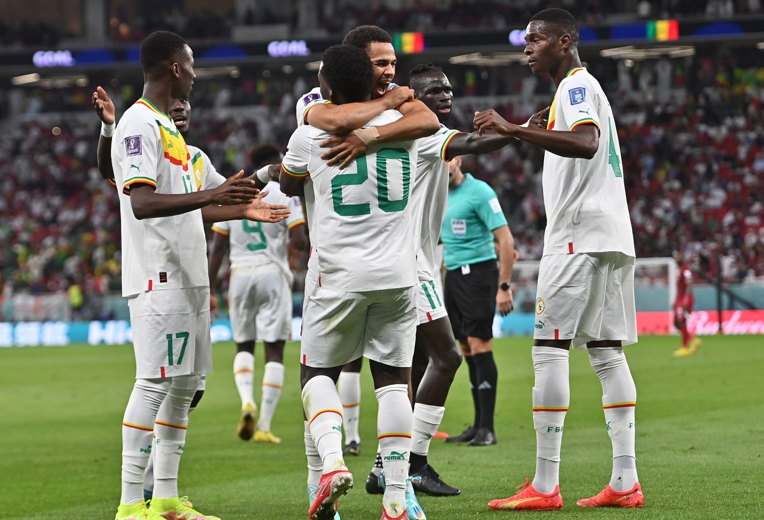 epa10327722 Bamba Dieng (C) of Sengal celebrates with teammates after scoring the team&#039;s third goal uring the FIFA World Cup 2022 group A soccer match between Qatar and Senegal at Al Thumama Stad ...
