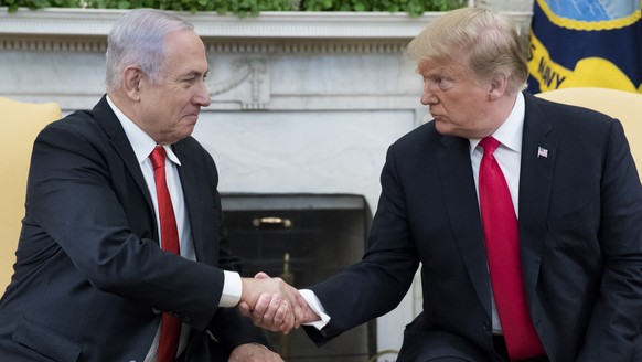 epa07462976 US President Donald J. Trump (R) and Prime Minister of Israel Benjamin Netanyahu (L) shake hands in the Oval Office of the White House in Washington, DC, USA, 25 March 2019. Trump earlier  ...