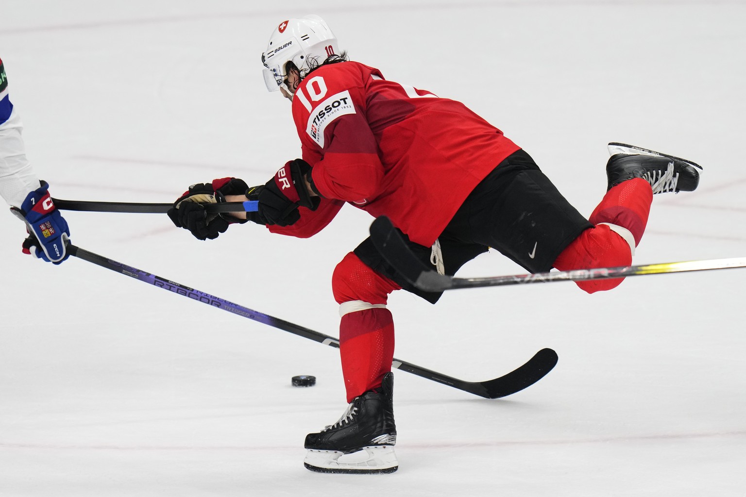 Switzerland&#039;s Andres Ambuhl is tripped during the preliminary round match between Czech Republic and Switzerland at the Ice Hockey World Championships in Prague, Czech Republic, Monday, May 13, 2 ...