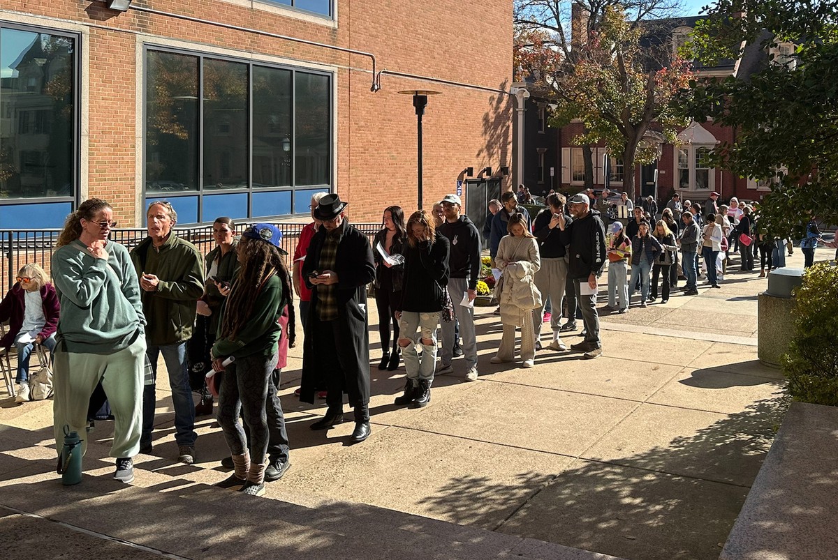 People wait in line outside the Bucks County government building to apply for an on-demand mail ballot on the last day to request one in Doylestown, Pa., Tuesday, Oct. 29, 2024. (AP Photo/Mike Catalin ...