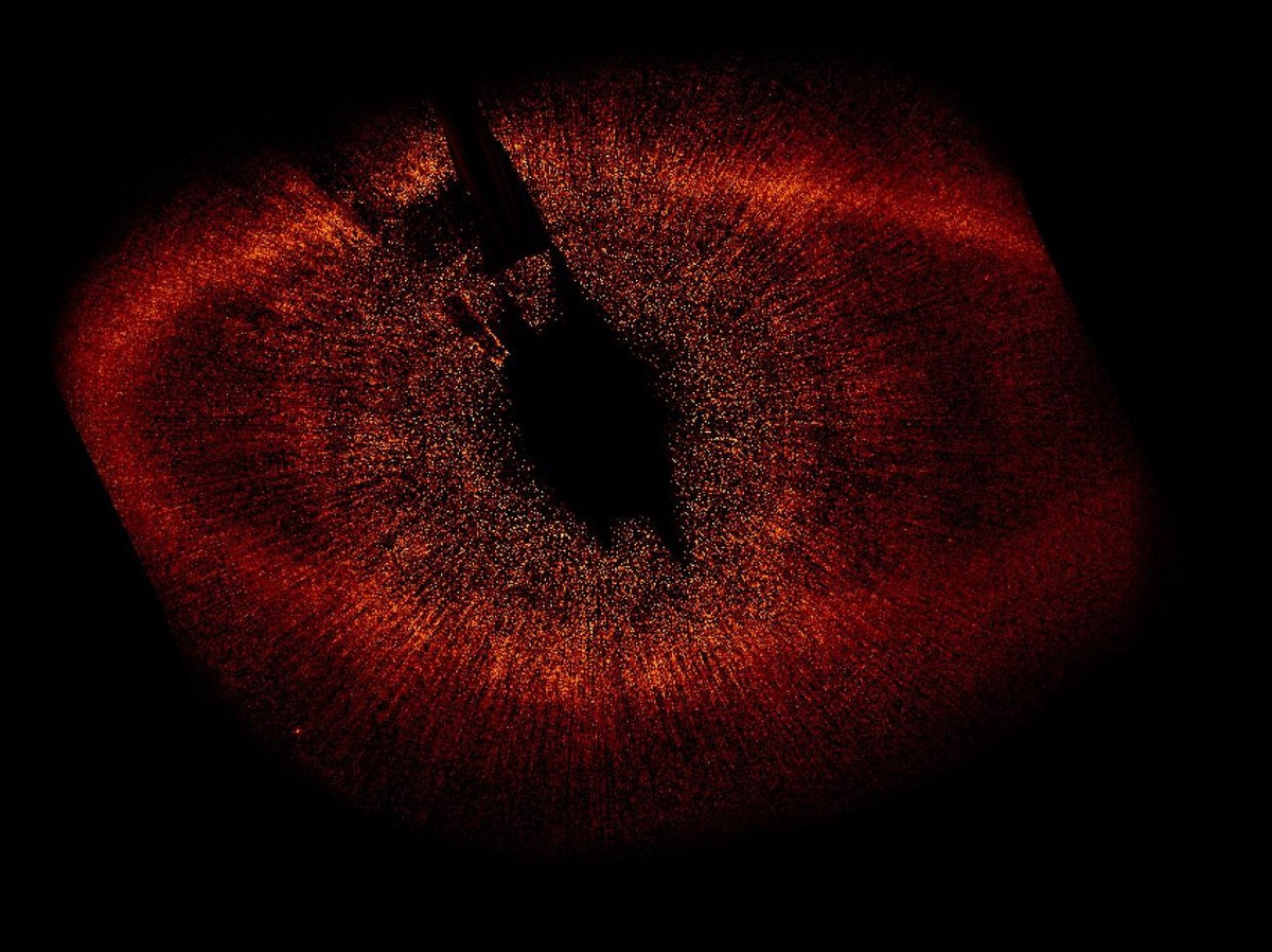 In this image released by NASA, a dust ring, seen in red, surround the star Fomalhaut, that resides at the center of the image, and not visible to the human eye in this image. The Hubble Telescope dis ...