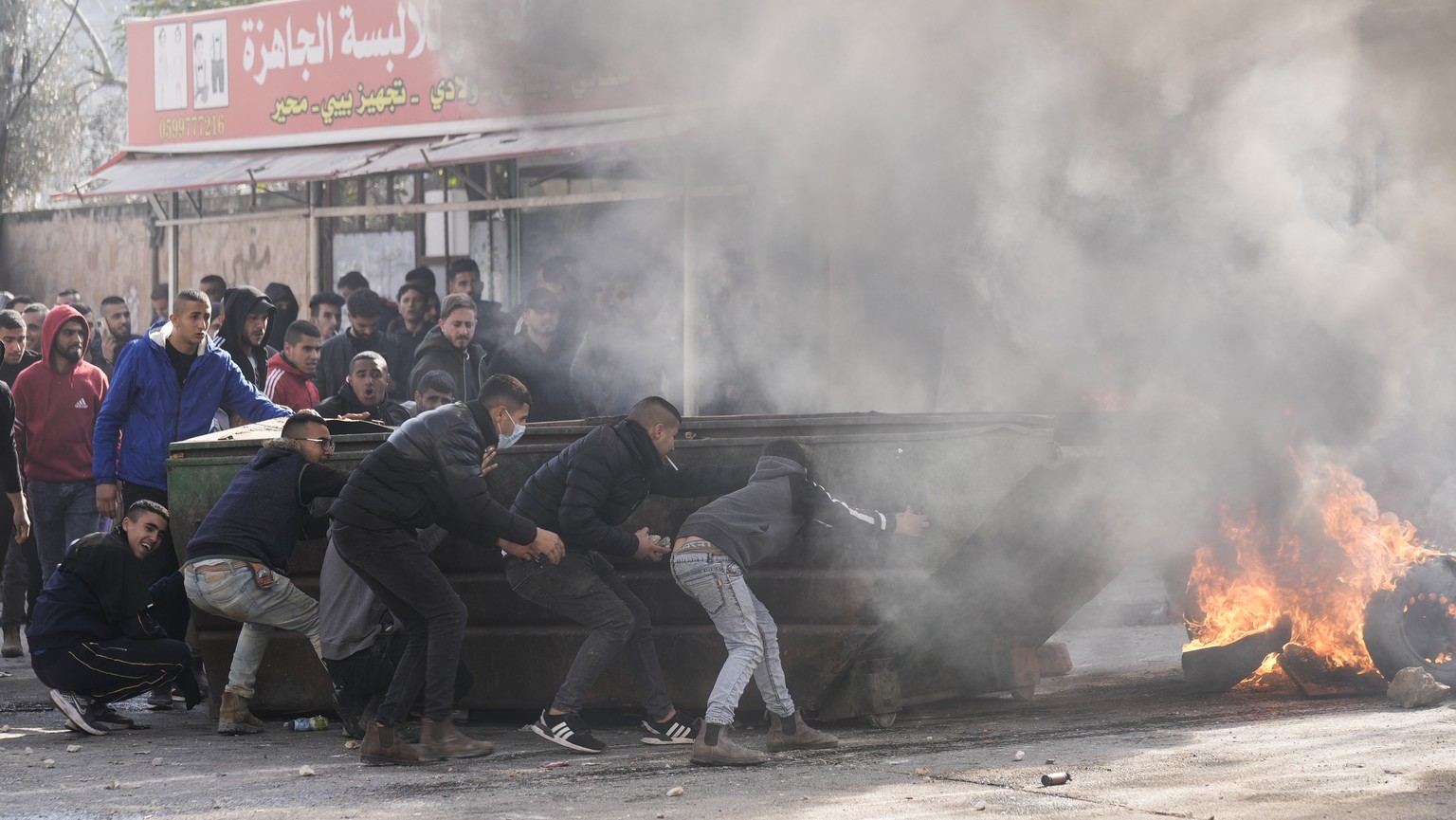 Palestinians clash with Israeli forces following an army raid in the West Bank city of Jenin, Thursday, Jan. 26, 2023. (AP Photo/Majdi Mohammed)