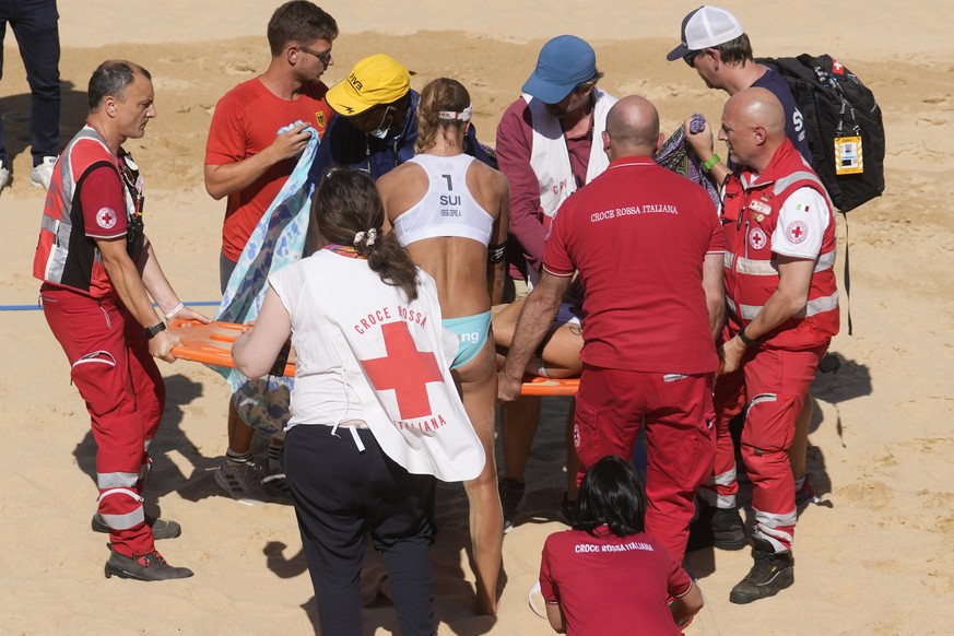 Switzerland&#039;s Joana Heidrich is carried away on a stretcher after injuring her shoulder during the beach volley final for the third place between Germany&#039;s Mueller-Tillmann and Switzerland&# ...