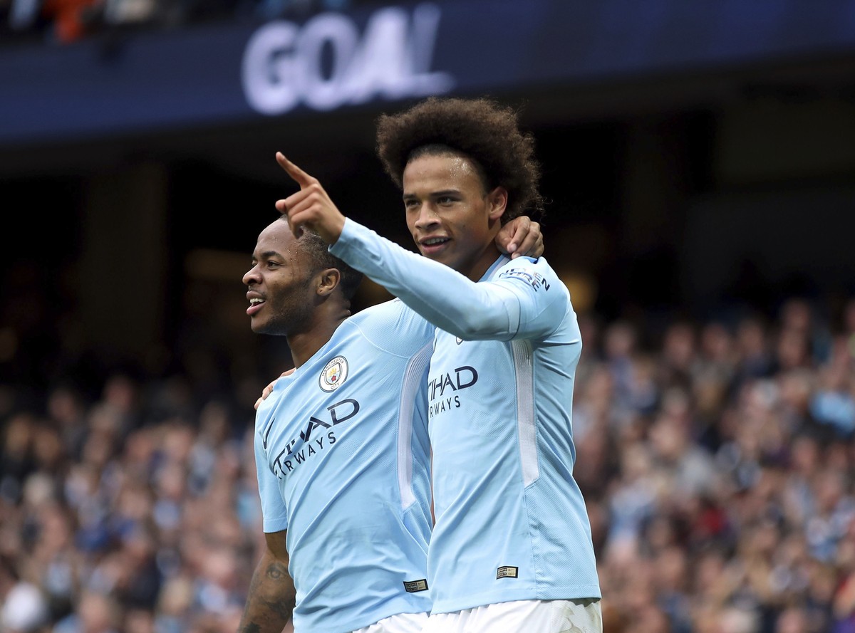 Manchester City's Raheem Sterling, left, celebrates scoring his side's second goal of the game with teammate Leroy Sane, during the English Premier League soccer match between Manchester Cit ...