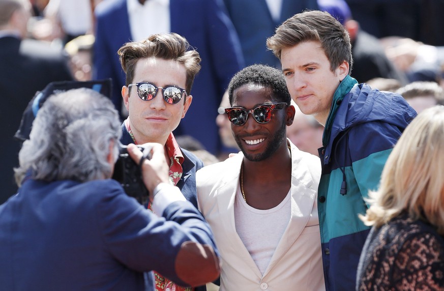 Radio 1 DJ Nick Grimshaw (L), Musician Tinie Tempah (C) and BBC presenter Greg James have their photograph taken before the presentation of Burberry Prorsum during its London Collections: Men show in  ...