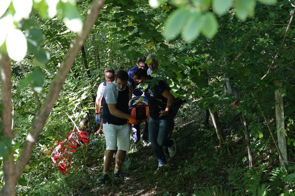 Cyclist Remco Evenepoel of Belgium is taken away on a stretcher after falling during the Tour of Lombardy cycling race, from Bergamo to Como, Italy, Saturday, Aug. 15, 2020. (Fabio Ferrari/LaPresse vi ...