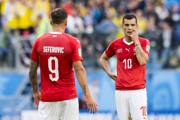 Switzerland&#039;s forward Haris Seferovic, left, and Switzerland&#039;s midfielder Granit Xhaka, right, react during the FIFA World Cup 2018 round of 16 soccer match between Sweden and Switzerland at ...