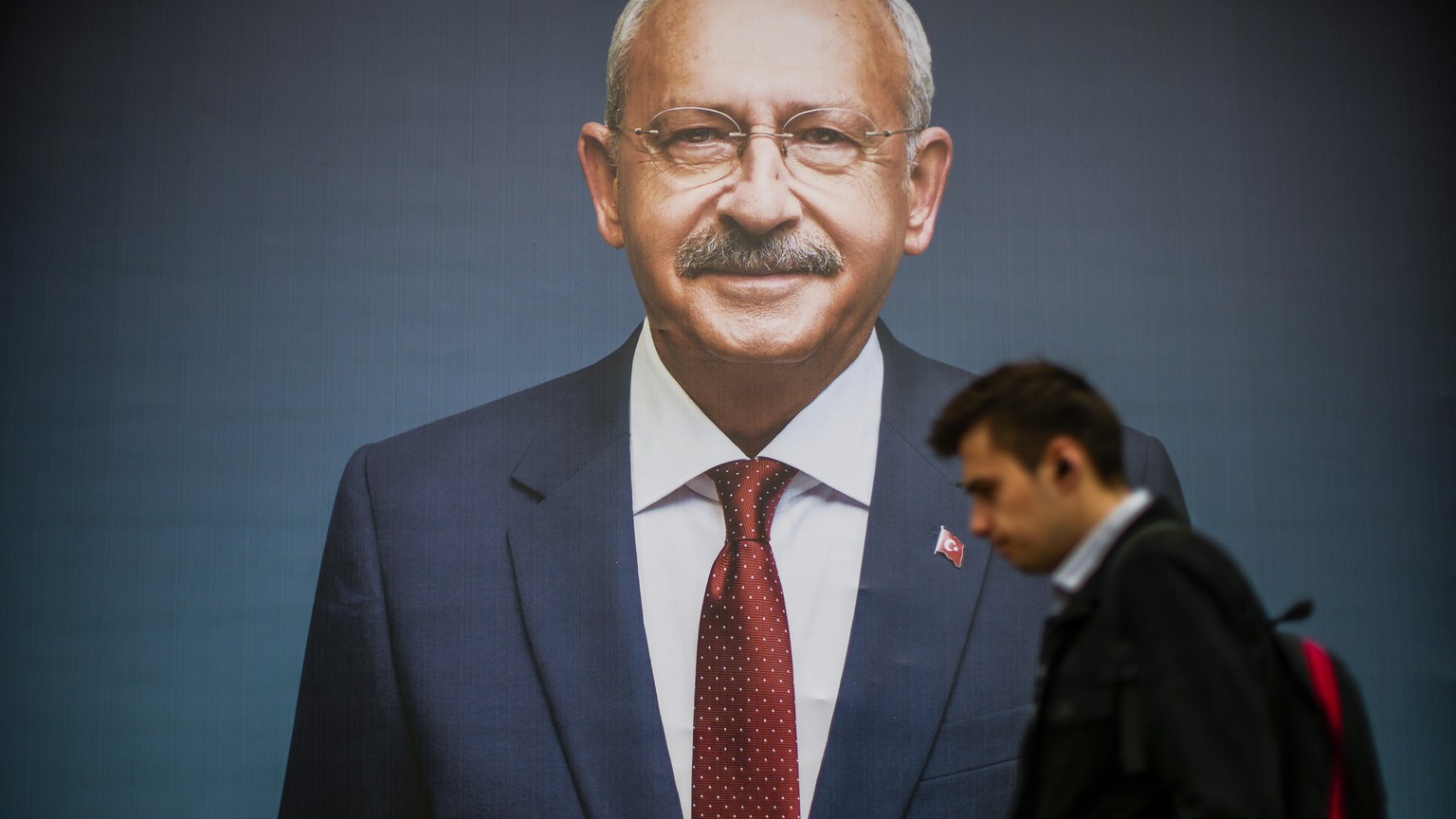 A man walks past a billboard of Turkey's CHP party leader and Nation Alliance presidential candidate, Kemal Kilicdaroglu, a day after presidential election day, in Istanbul, Turkey, Monday, Ma…