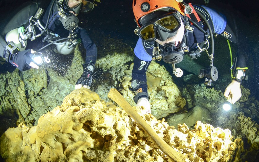 This undated photo released by Mexico&#039;s National Anthropology and History Institute (INAH), shows divers from the Great Mayan Aquifer project exploring the Sac Actun underwater cave system where  ...