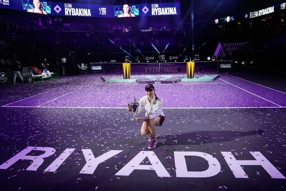 Elena Rybakina of Kazakhstan poses with the trophy after defeating Aryna Sabalenka of Belarus in the women's final singles match of the WTA finals in Riyadh, Saudi Arabia, Saturday, Nov. 8, 2025. ...