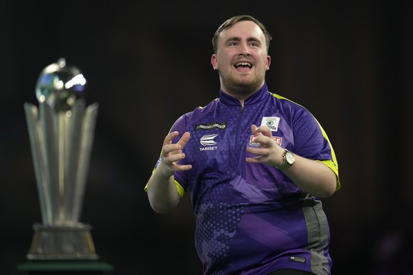Luke Littler gestures during the final match against Luke Humphries of England at the World Darts Championship, in London, Wednesday, Jan. 3, 2024. (AP Photo/Kin Cheung)