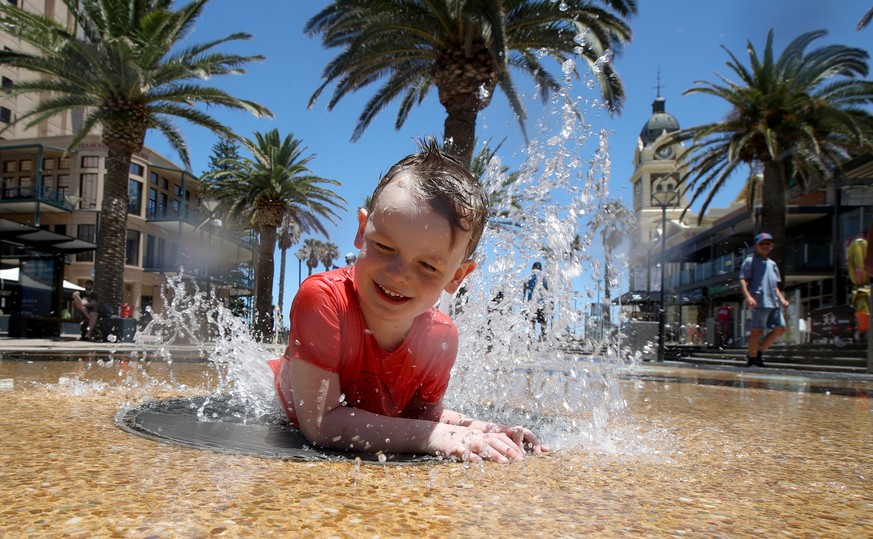 epa07250203 Five-year-old Kia cools down from the Hot weather at Glenelg beach in Adelaide, South Australia, Australia, 26 December 2018 (issued 27 December 2018). Severe fire danger is forecast east  ...