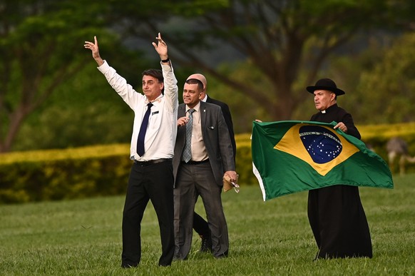 epa10362616 The president of Brazil, Jair Bolsonaro (L), meets with his supporters in front of the Palacio de la Alvorada in Brasília, Brazil, 12 December 2022. Bolsonaro has had an almost non-existen ...