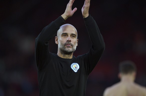 Manchester City manager Pep Guardiola applauds fans at the end of the English Premier League soccer match between Liverpool and Manchester City at Anfield, Liverpool, England, Sunday Oct. 3, 2021. (Pe ...