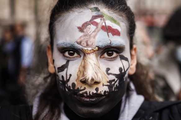epa10219686 A woman with her face painted participates in a rally in support of Iranian women in Paris, France, 02 October 2022. This demonstration takes place following the deaths of Mahsa Amini, who ...