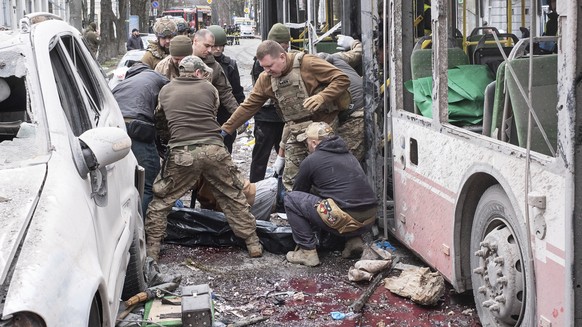Ukrainian servicemen carry a dead body from a trolleybus after a Russian missile strike on Sumy, Ukraine, Sunday, April 13, 2025. (AP Photo/Volodymyr Hordiienko)
Russia Ukraine War